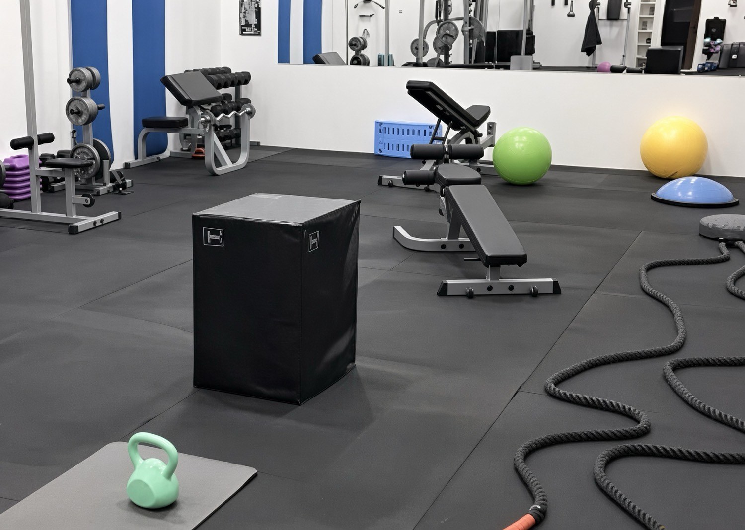 Plyo box, benches, and battle ropes in the studio