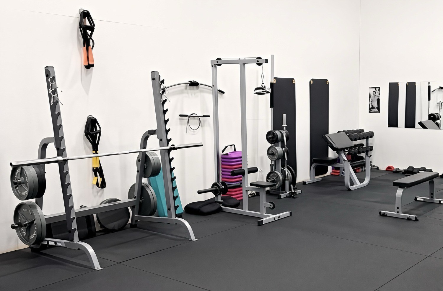 Squat racks and cable machine along the studio wall